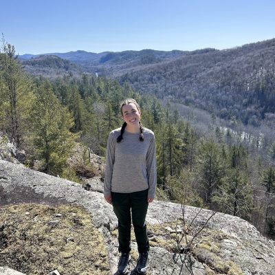 Woman standing on rocky outcrop