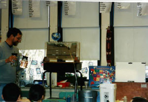 Man teaching with a groundwater model in an elementary classroom in the 1990s.