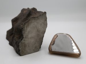 Cut piece of metallic meteorite and polished slab of metallic meteorite